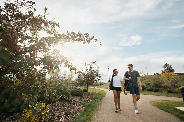 Couple Walking The Orchards Community Edmonton Ab