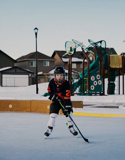 Young resident playing hockey at The Orchards Community